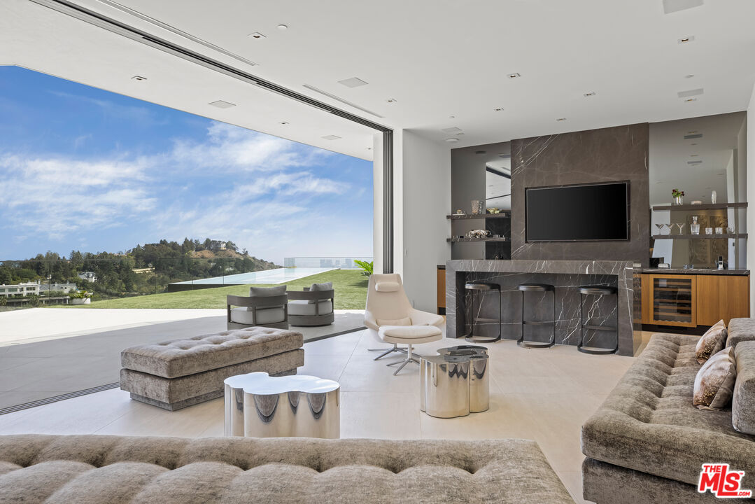 9674 Highridge Drive Beverly Hills, CA 90210 - Photo 5 of 29 a living room with furniture and a flat screen tv