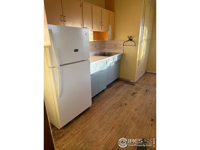 a kitchen with a refrigerator and a stove