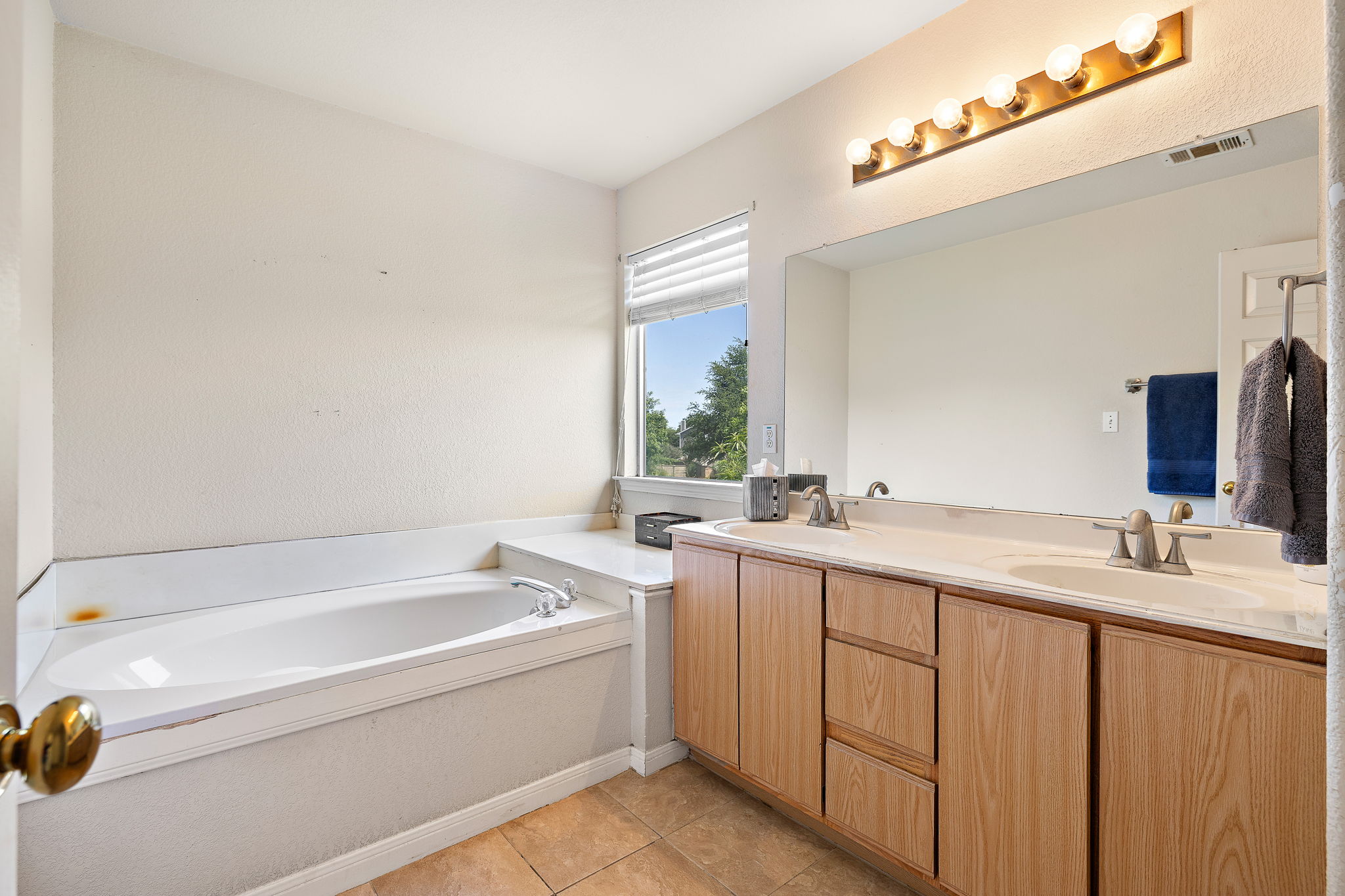 615 Runners Ridge Pflugerville, TX 78660 - Photo 20 of 32 a bathroom with a granite countertop sink mirror and a bathtub