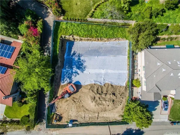an aerial view of a house with a yard and a fountain
