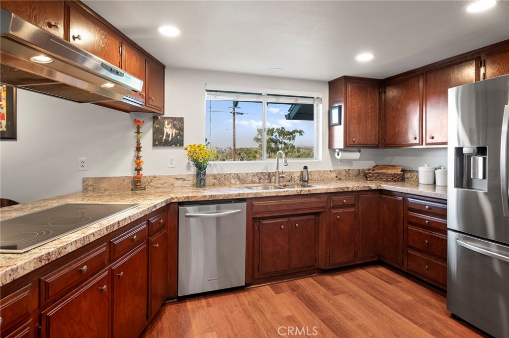 3495 Ridgecrest Drive Carlsbad, CA 92008 - Photo 24 of 42 a kitchen with stainless steel appliances granite countertop a sink dishwasher stove and refrigerator