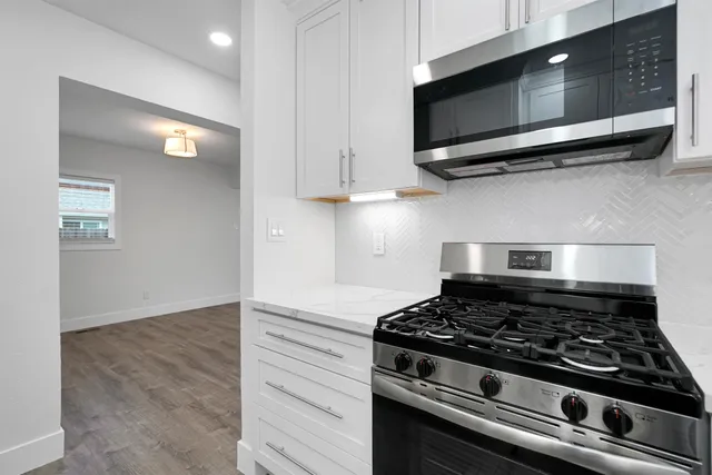 a stove top oven sitting inside of a kitchen