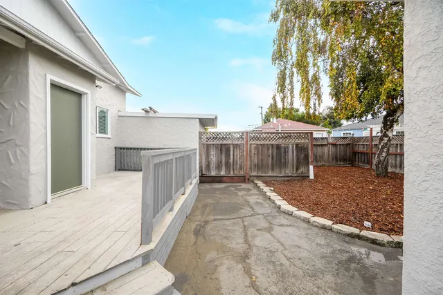 a view of a house with backyard and trees
