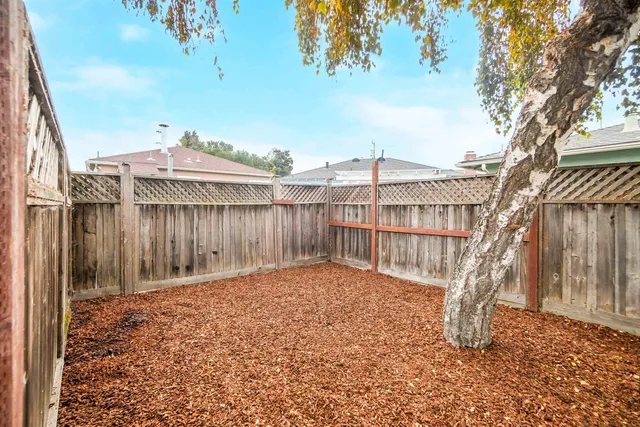 a view of a house with a wooden fence