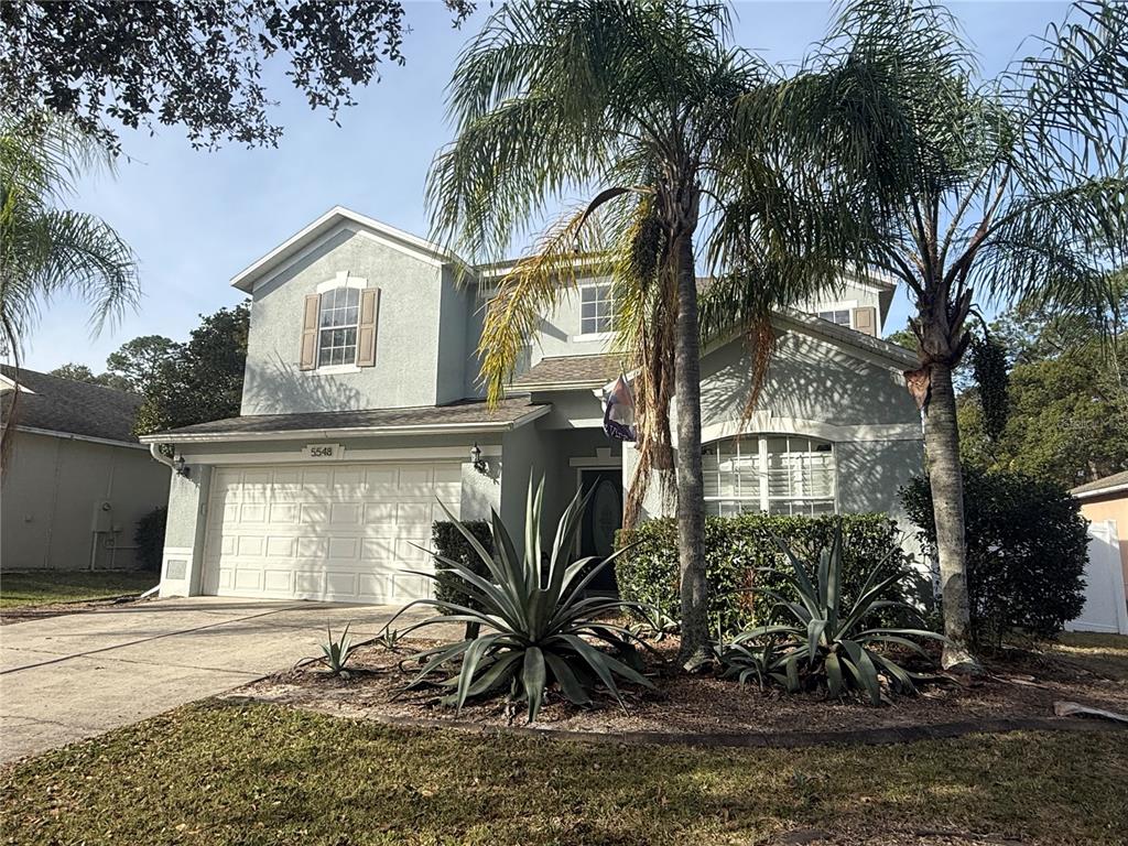 5548 Ansley Way Mount Dora, FL 32757 - Photo 2 of 2 a front view of a house with a yard