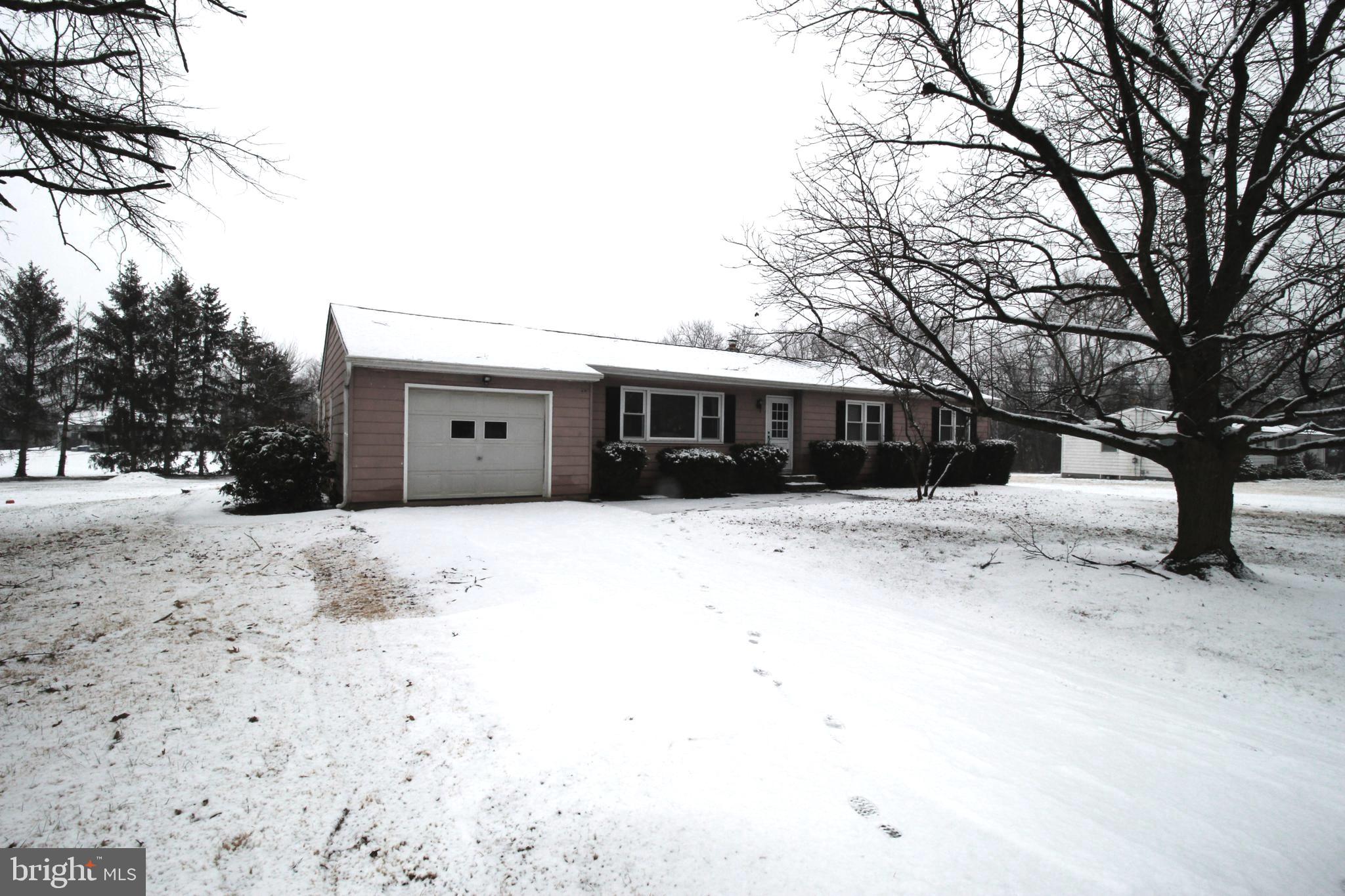 a view of house with a yard covered in snow