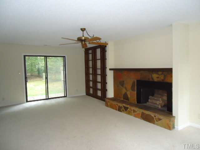 3060 Colony Road, Unit C Durham, NC 27705 - Photo 3 of 15 a view of an empty room with a fireplace and a window
