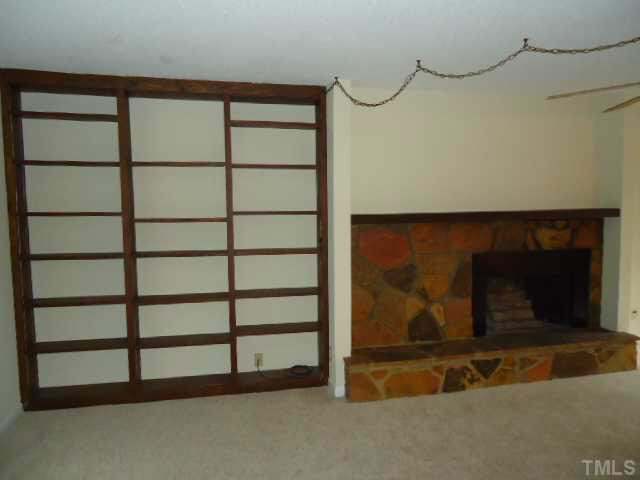 3060 Colony Road, Unit C Durham, NC 27705 - Photo 4 of 15 a room with a wooden floor and a cabinet