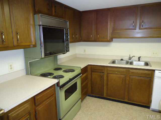 3060 Colony Road, Unit C Durham, NC 27705 - Photo 6 of 15 a kitchen with granite countertop a sink stove and cabinets