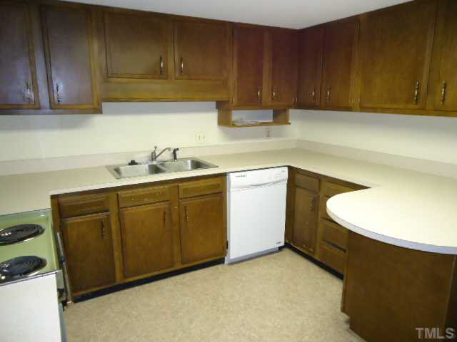 3060 Colony Road, Unit C Durham, NC 27705 - Photo 7 of 15 a kitchen with a sink a stove and cabinets