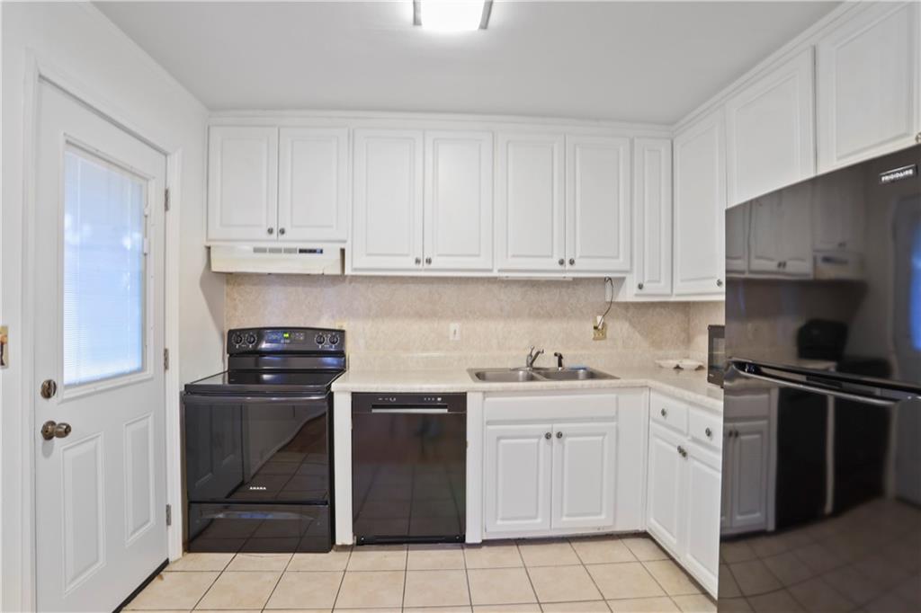 20 26th Street Northwest, Unit B1 Atlanta, GA 30309 - Photo 11 of 21 a kitchen with a stove sink and cabinets