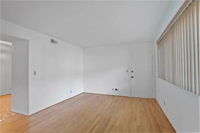 a view of a room with wooden floor