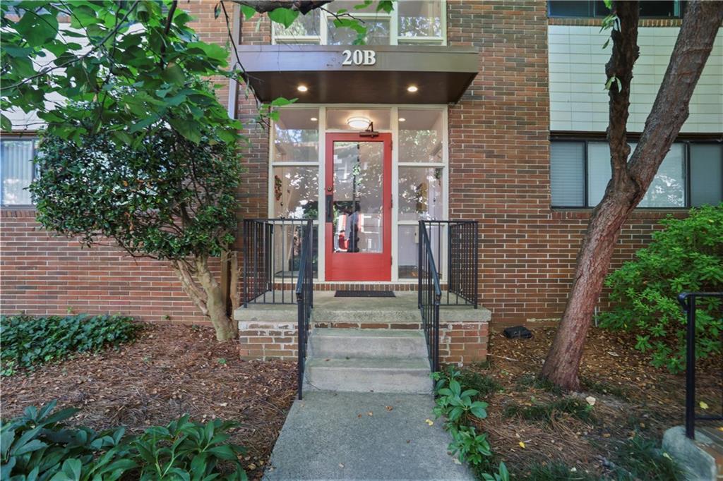 20 26th Street Northwest, Unit B1 Atlanta, GA 30309 - Photo 2 of 21 a view of brick house with a small yard and large tree