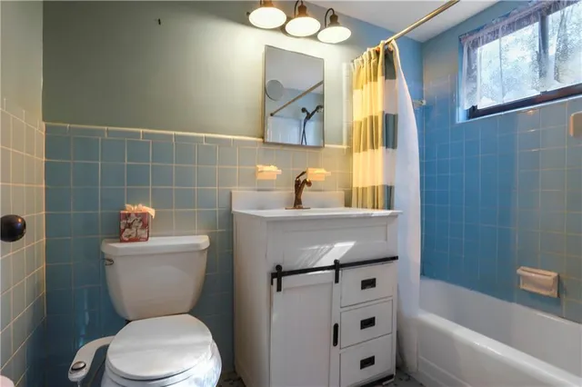 a bathroom with a sink mirror toilet and shower