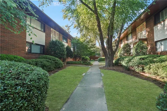 a view of a pathway with a house in the background