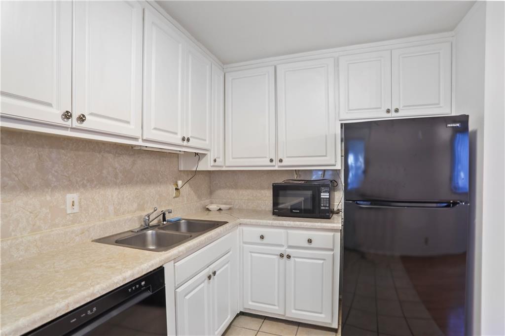 20 26th Street Northwest, Unit B1 Atlanta, GA 30309 - Photo 6 of 21 a kitchen with appliances a sink and cabinets