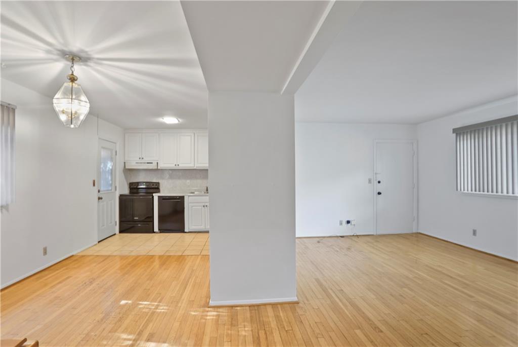 20 26th Street Northwest, Unit B1 Atlanta, GA 30309 - Photo 7 of 21 a view of a kitchen with wooden floor and a ceiling fan