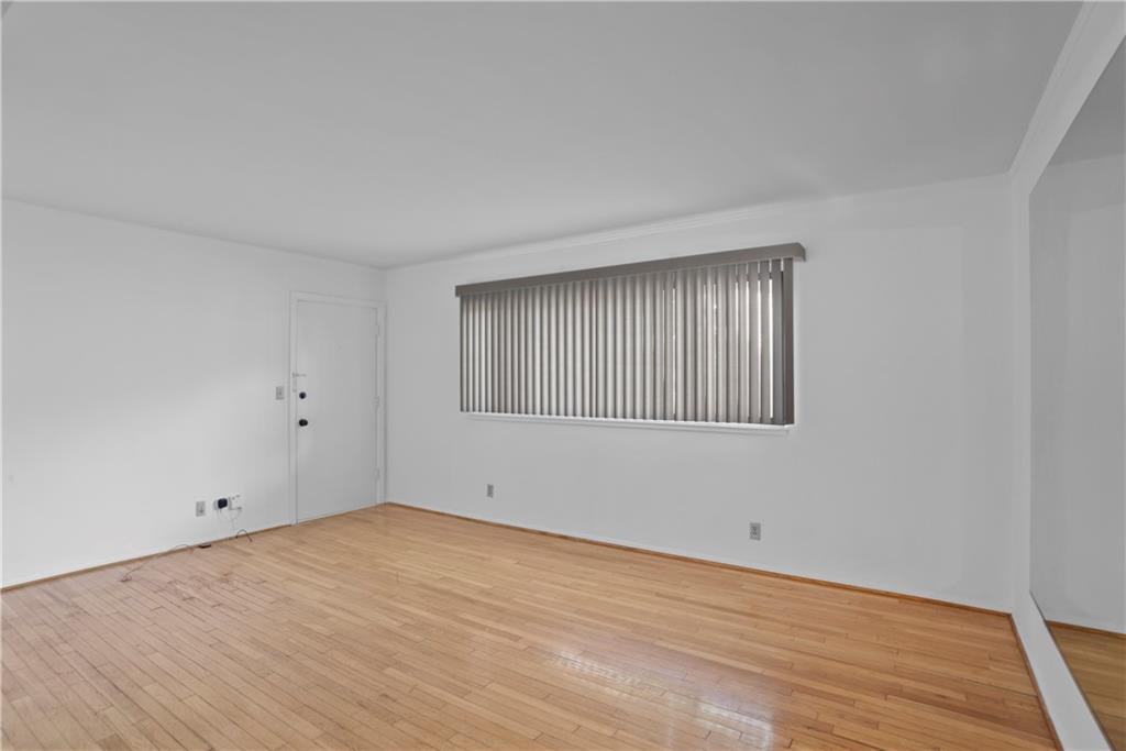 20 26th Street Northwest, Unit B1 Atlanta, GA 30309 - Photo 8 of 21 a view of an empty room with wooden floor and a window