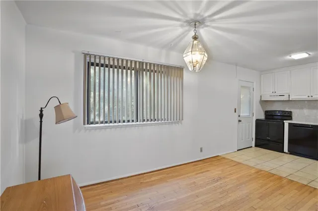 a view of a kitchen with an empty space and a window