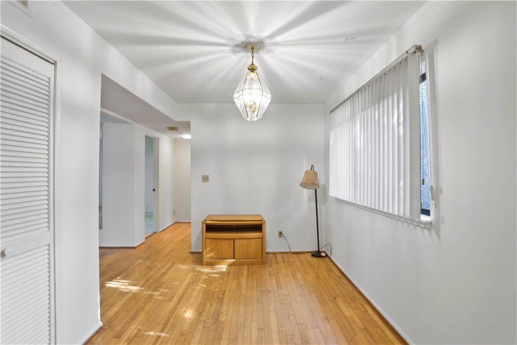 20 26th Street Northwest, Unit B1 Atlanta, GA 30309 - Photo 10 of 21 a view of an empty room with wooden floor and a window