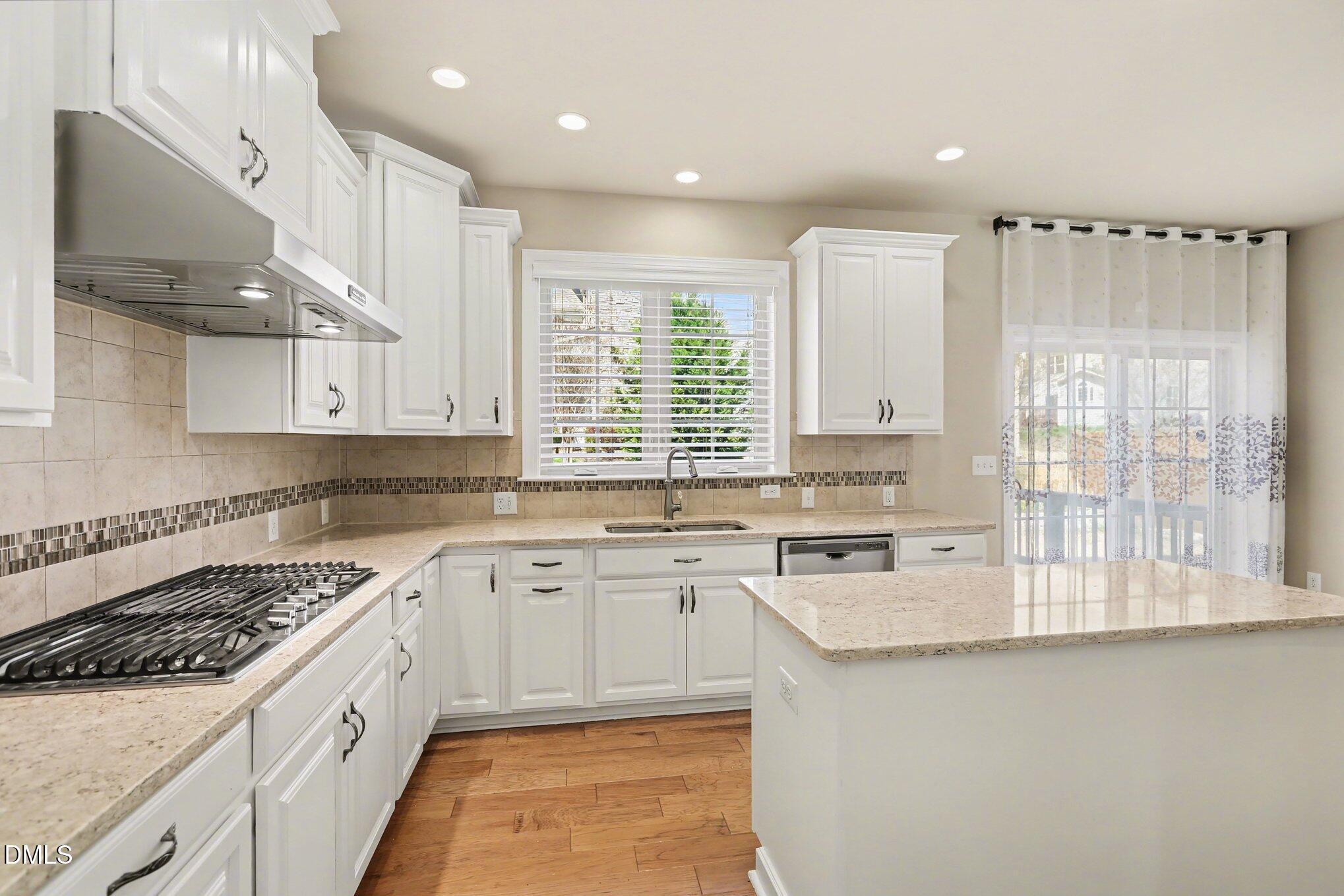 351 Gartrell Way Cary, NC 27519 - Photo 20 of 51 a kitchen with a sink stove and cabinets