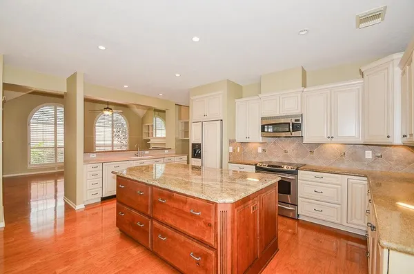 a kitchen with stainless steel appliances granite countertop a stove and a sink
