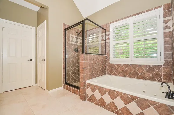 a bathroom with a bathtub and a shower