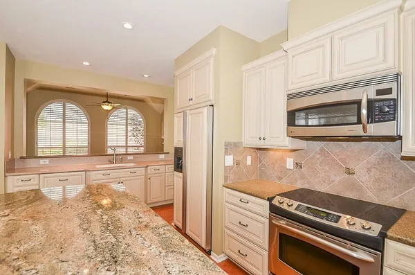 a kitchen with a refrigerator stove and sink