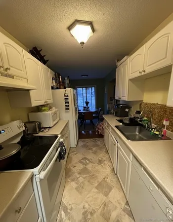 a kitchen that has a sink and a stove