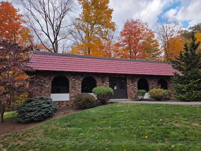 a view of a house with a garden and plants