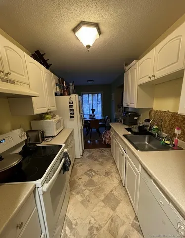 a kitchen that has a sink and a stove
