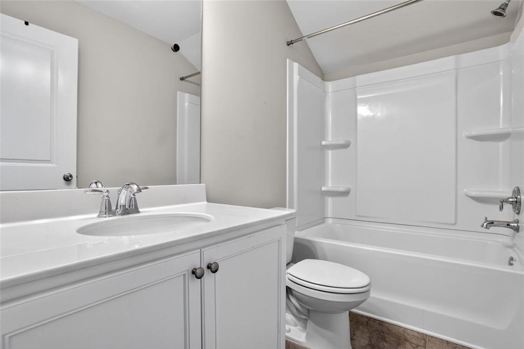 1553 Spring Hollow Way Stone Mountain, GA 30083 - Photo 19 of 27 a bathroom with a sink a toilet and a bathtub