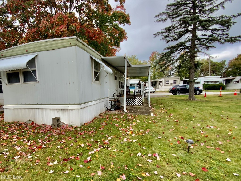 4199 Massillon Road, Unit 223 Uniontown, OH 44685 - Photo 2 of 20 View of property exterior with a lawn