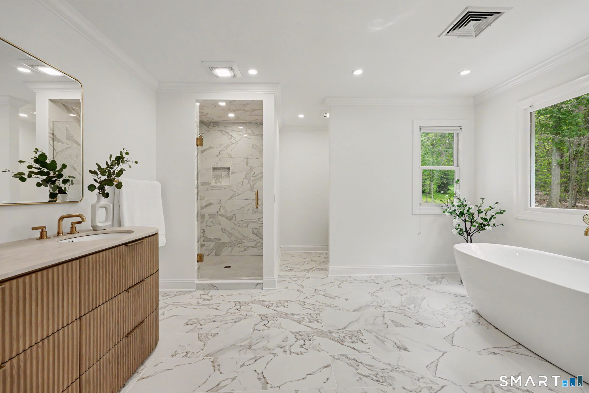 10 Side Hill Road Westport, CT 06880 - Photo 24 of 40 a bathroom with a bathtub sink and mirror