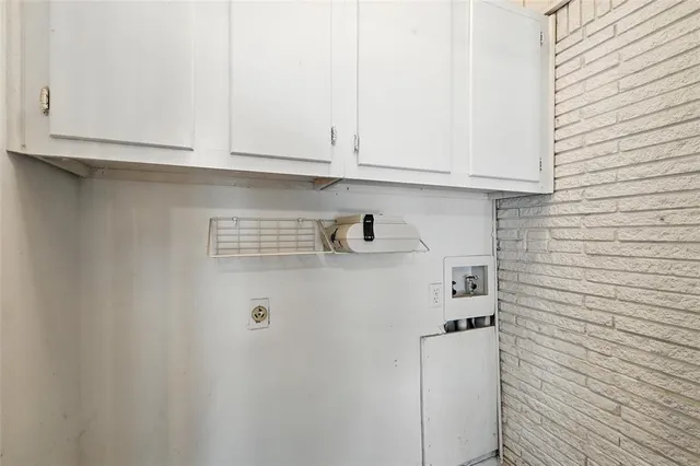 a view of kitchen with white cabinets