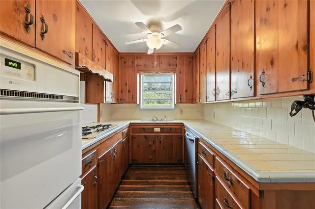 a kitchen with a sink stove and microwave