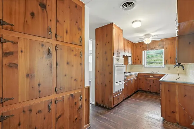 a kitchen with stainless steel appliances a sink and cabinets