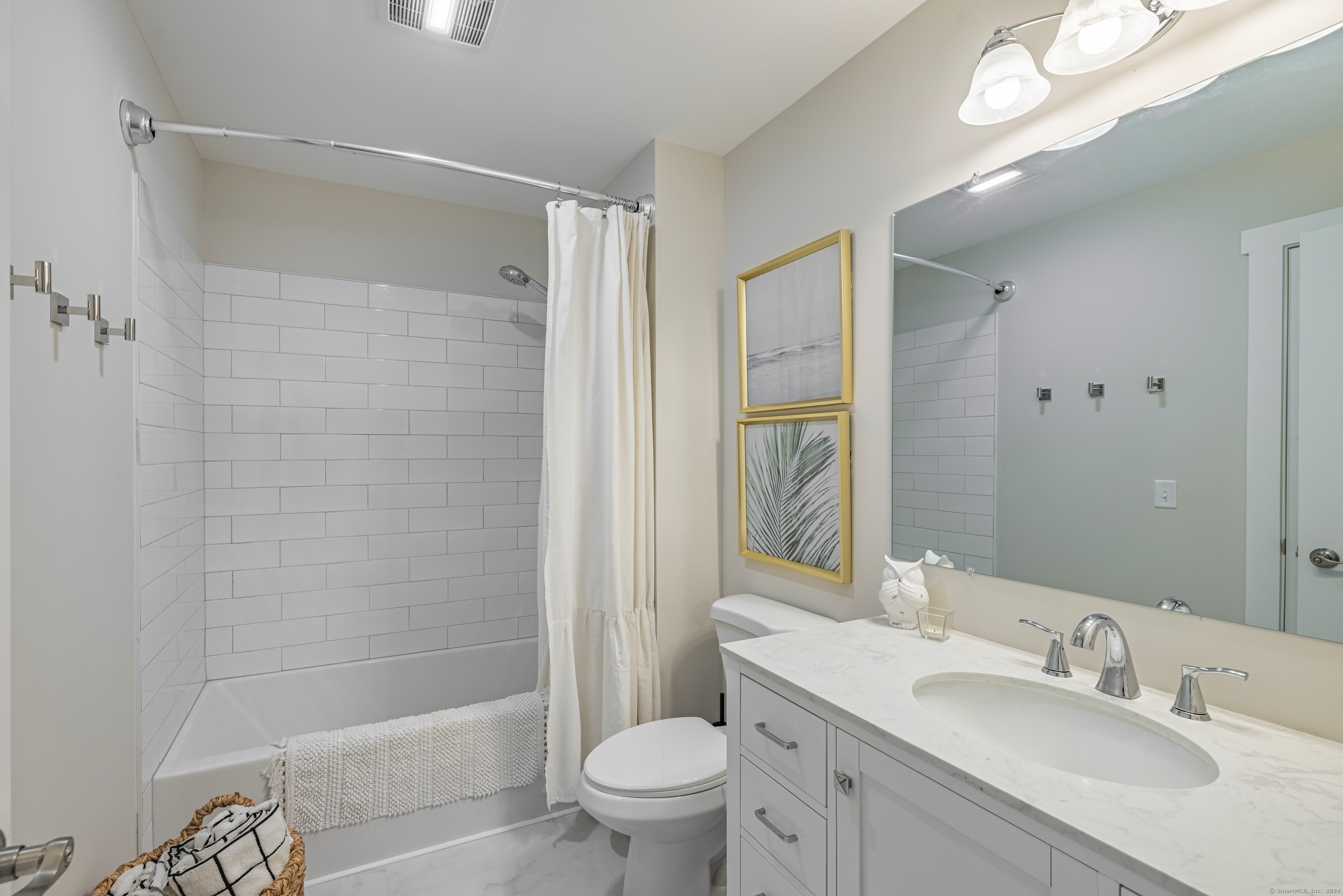 94 North Bridebrook Road, Unit 201 East Lyme, CT 06357 - Photo 16 of 19 a bathroom with a sink a toilet and shower a mirror