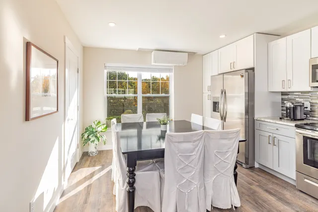 a view of a dining room with furniture window and wooden floor