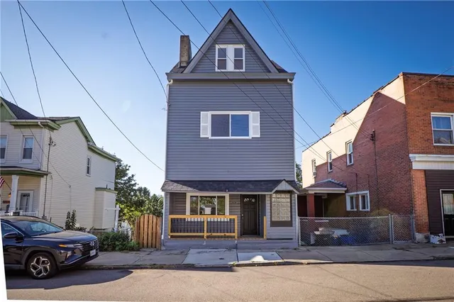 a front view of a house with yard