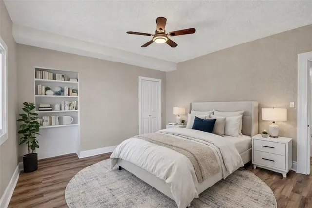 a bedroom with a bed and a potted plant