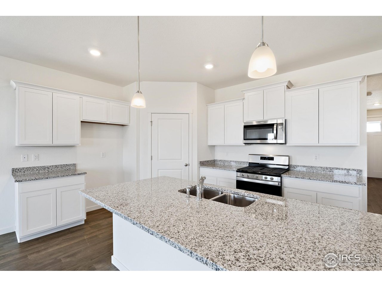 944 London Way Severance, CO 80550 - Photo 13 of 27 a kitchen with stainless steel appliances granite countertop a sink stove and refrigerator