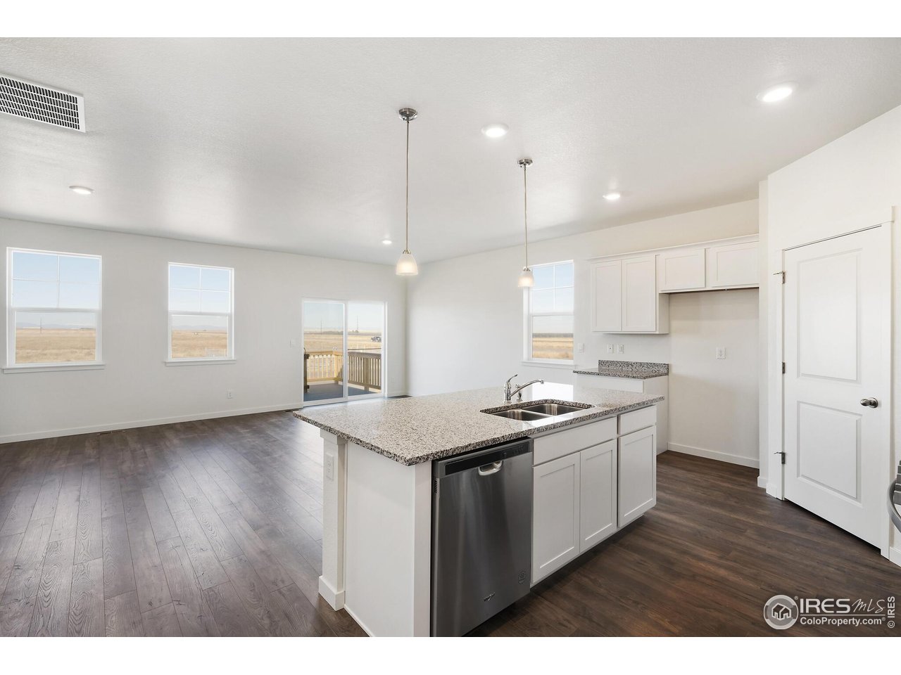 944 London Way Severance, CO 80550 - Photo 16 of 27 a kitchen with a sink and wooden floor