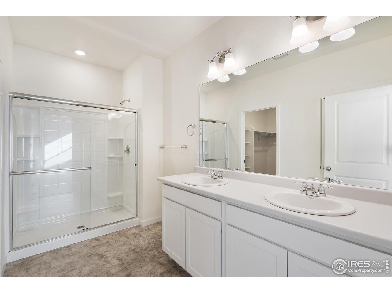 944 London Way Severance, CO 80550 - Photo 20 of 27 a bathroom with a sink double vanity and shower