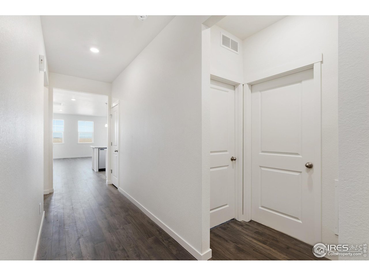 944 London Way Severance, CO 80550 - Photo 4 of 27 a view of a hallway with wooden floor