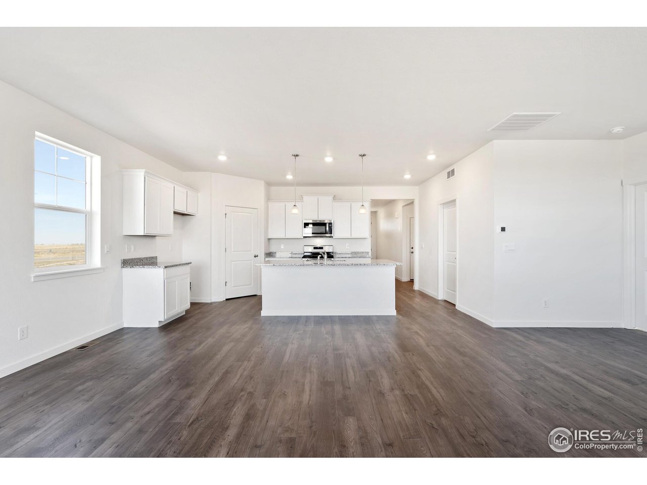 944 London Way Severance, CO 80550 - Photo 5 of 27 a view of kitchen with wooden floor