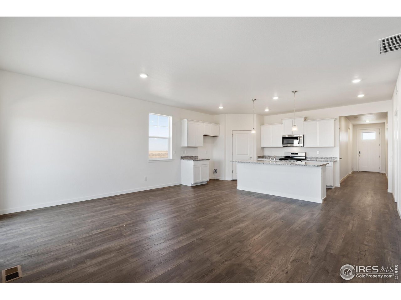 944 London Way Severance, CO 80550 - Photo 6 of 27 a view of kitchen with kitchen island and stainless steel appliances