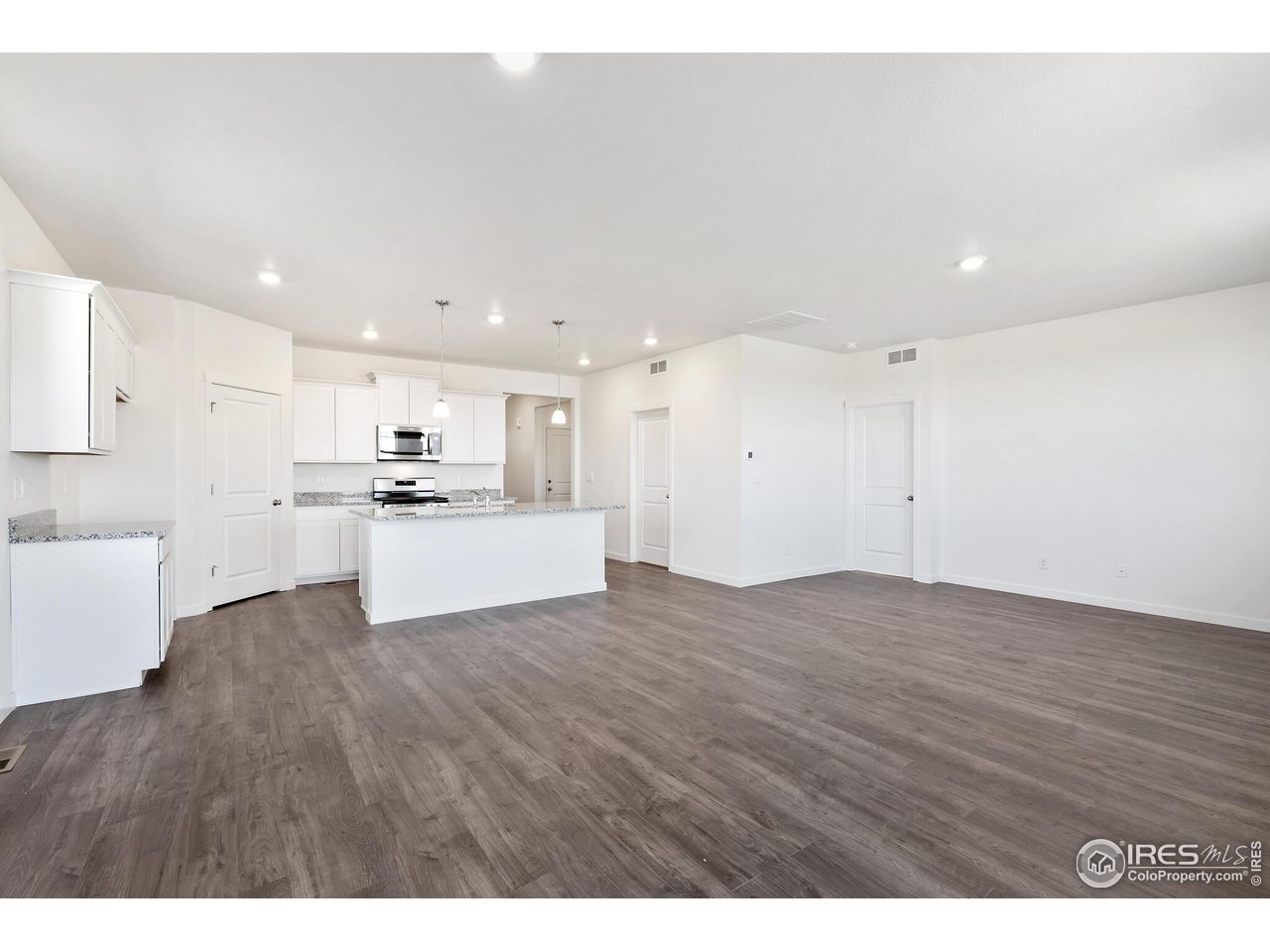 944 London Way Severance, CO 80550 - Photo 7 of 27 a view of kitchen with wooden floor