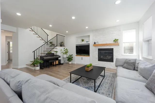 a living room with furniture and a fireplace