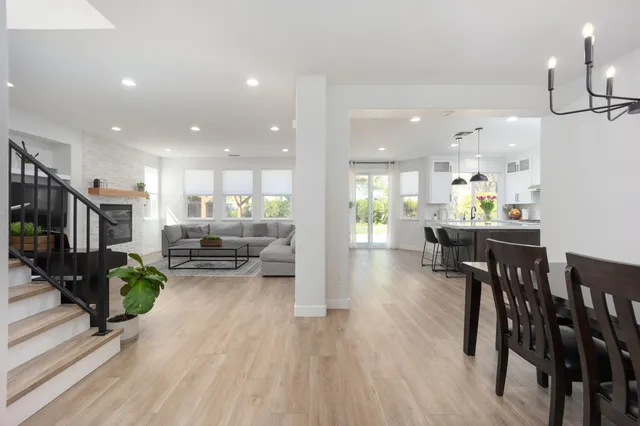 a view of kitchen with kitchen island dining table and wooden floor